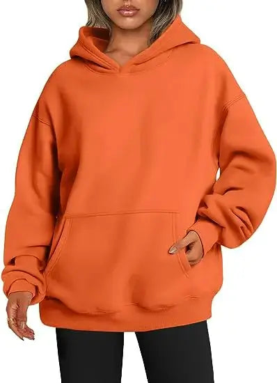 Womens hoodies with pockets big in vibrant orange color, showcasing oversized fit and front pocket for style and practicality.