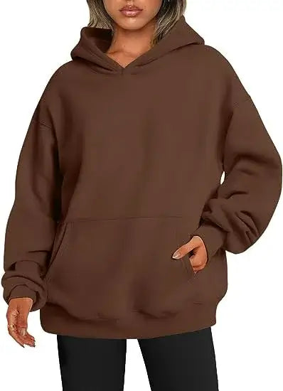 A woman wearing a brown oversized hoodie with pockets, showcasing comfort and style. Womens hoodies with pockets.